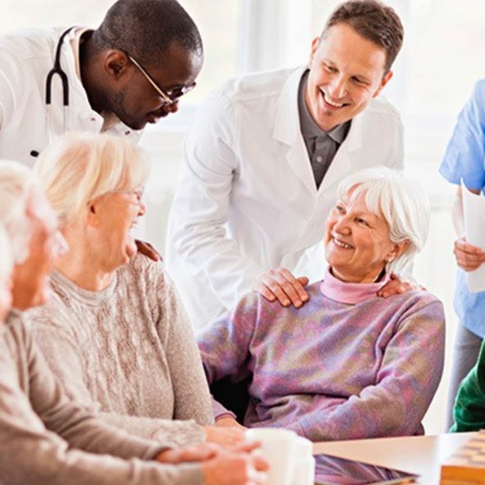 Caretaker holding a residents hand at Fox Hollow Independent and Assisted Living in Bend, Oregon