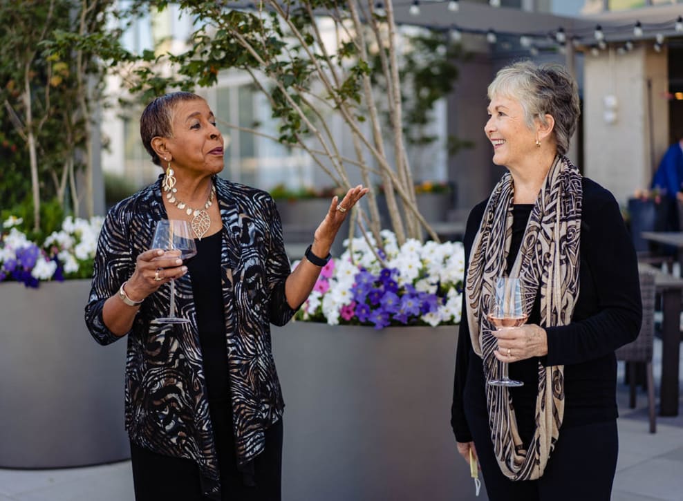 Residents talking on patio at Murano in Seattle, Washington