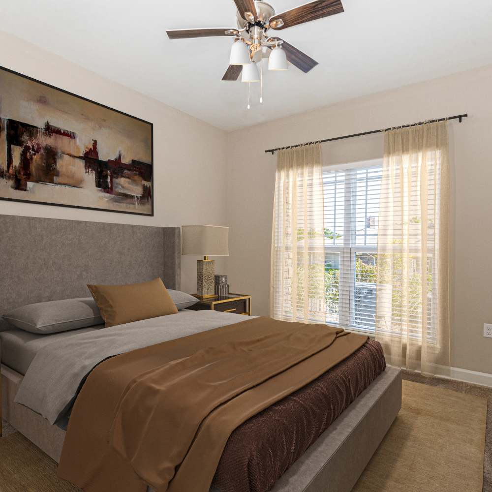 Bedroom with cozy bed and ceiling fan at Boulder Springs of Columbia in Columbia, Missouri