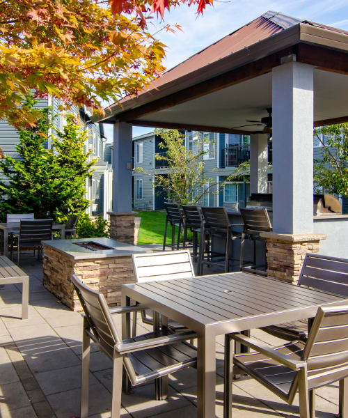 Exterior Common space, covered BBQ, fire-pit, and lounge at The Addison Apartments in Vancouver