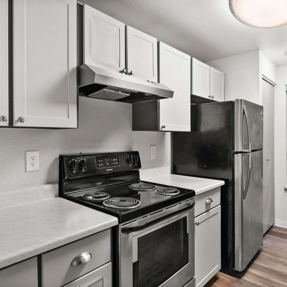Modern kitchen with a range and refrigerator at Lodge at Madrona Ridge in Tacoma, Washington
