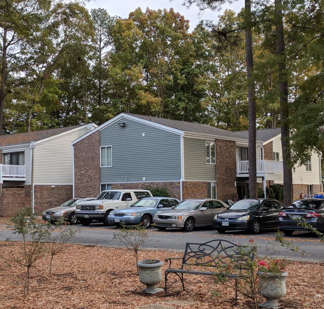 Exterior view of resident building and parking area at Residences at Sonoma Woods in Newport News, VA