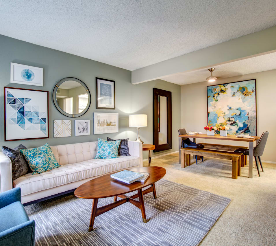 Dining area with a ceiling fan next to the living area in the open-concept floor plan of a model home at Vue Fremont in Fremont, California