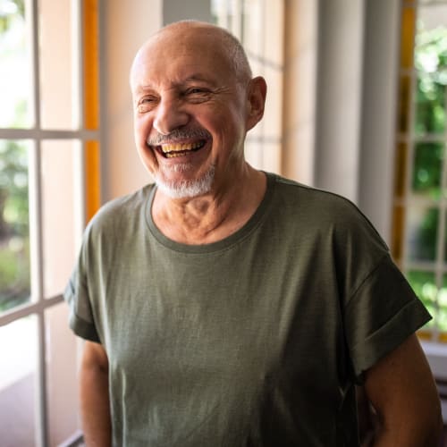 Senior man smiling in his apartment at Oxford Vista Wichita in Wichita, Kansas