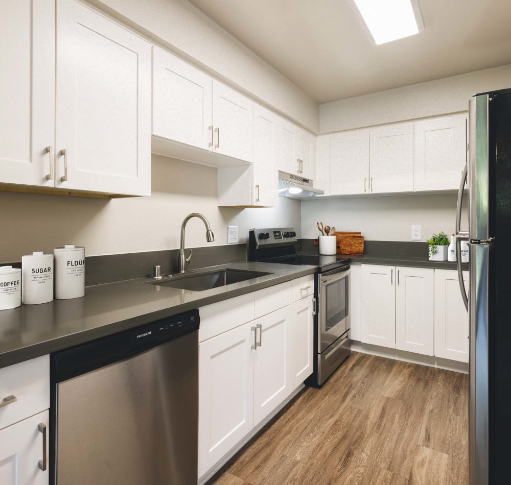 Model kitchen with stainless steel appliances and dishwasher at The Villas at Woodland Hills in Woodland Hills, California
