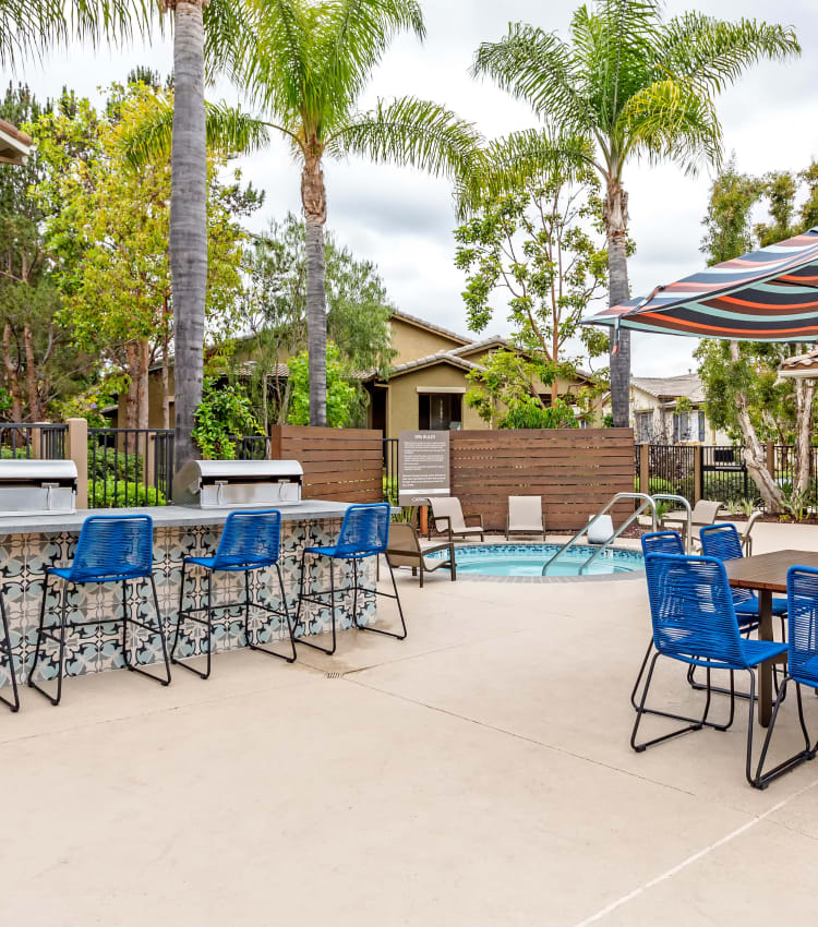 Barbecue area with gas grills near the swimming pool at Sofi Westview in San Diego, California
