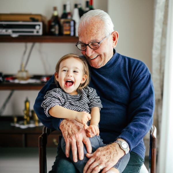 A resident holding his grandson at Pacifica Senior Living Menifee in Sun City, California.