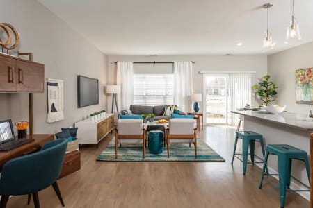Bright, well decorated living room at Woodland Acres Townhomes in Liverpool, New York