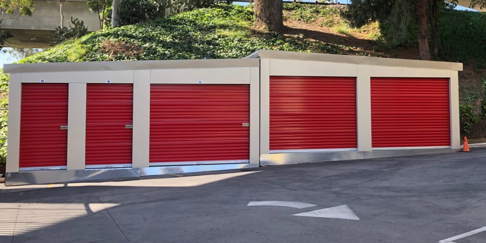 Drive-up storage units with red doors at StorQuest Self Storage in Los Angeles, California