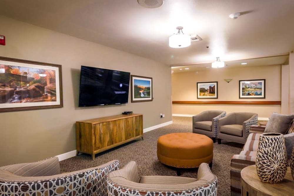 Spacious lounge area with tv at Evergreen Senior Living in Eugene, Oregon.
