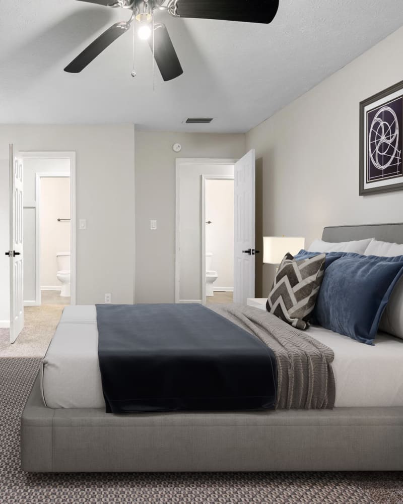 A large bed in a model apartment bedroom at Spring Creek Apartment Homes in Decatur, Georgia