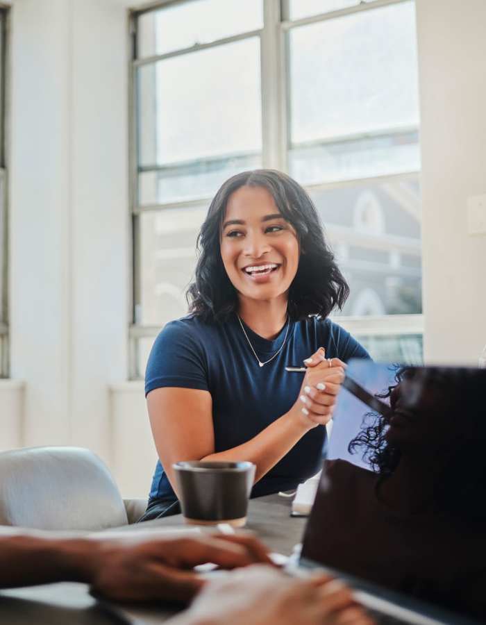 Happy employees around a conference table at Pegasus Residential in Alpharetta, Georgia