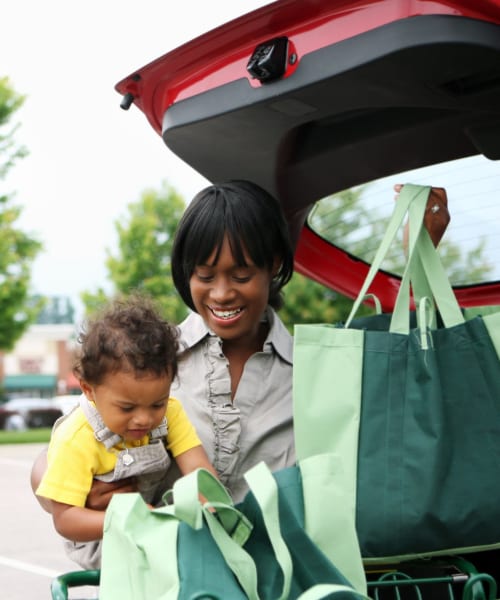 Resident loading her car with groceries after shopping near Victoria Station in Victoria, Texas