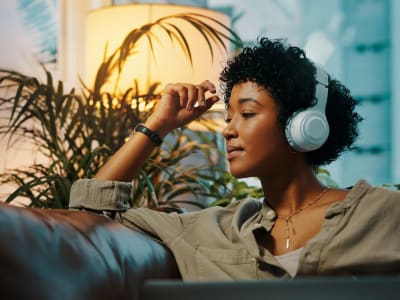 Woman wearing headphones and listening to music at Palace Apartments in Concord, California