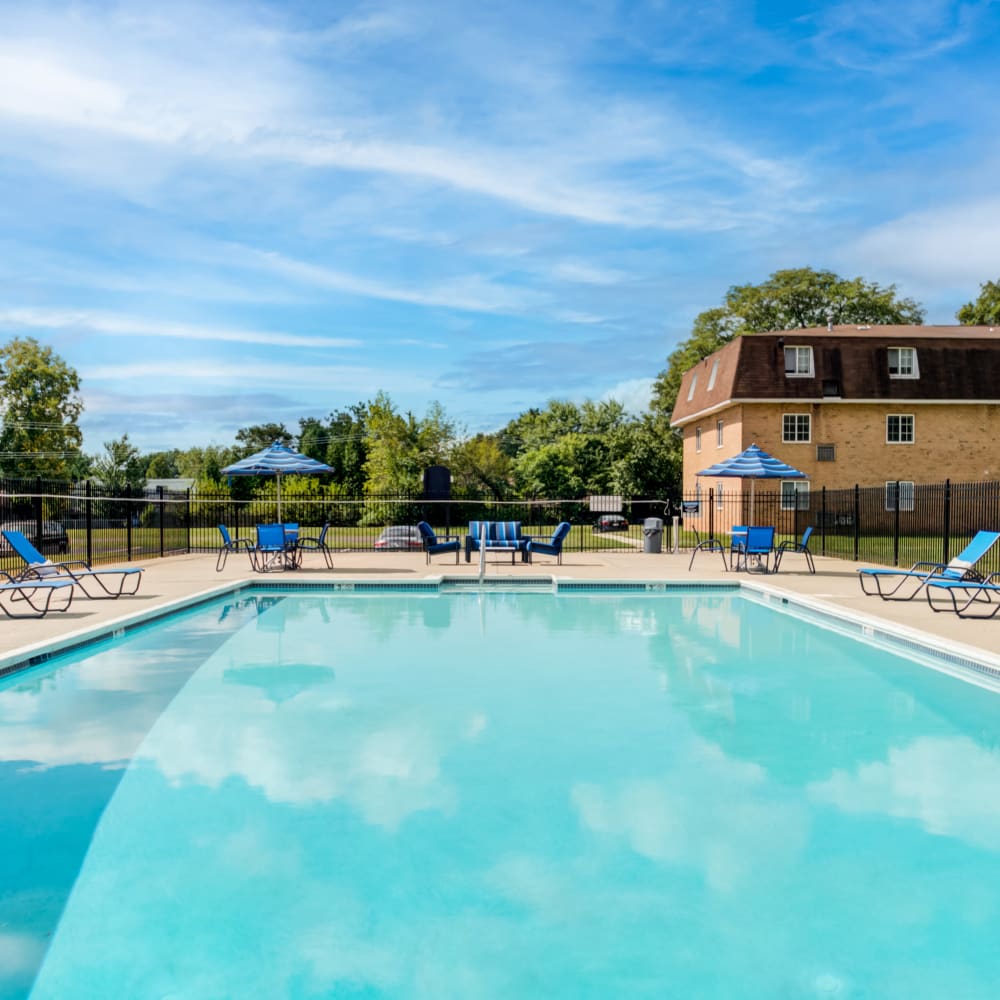 Swimming pool surrounded by lounge chairs at Main Street Apartment Homes in Lansdale, Pennsylvania