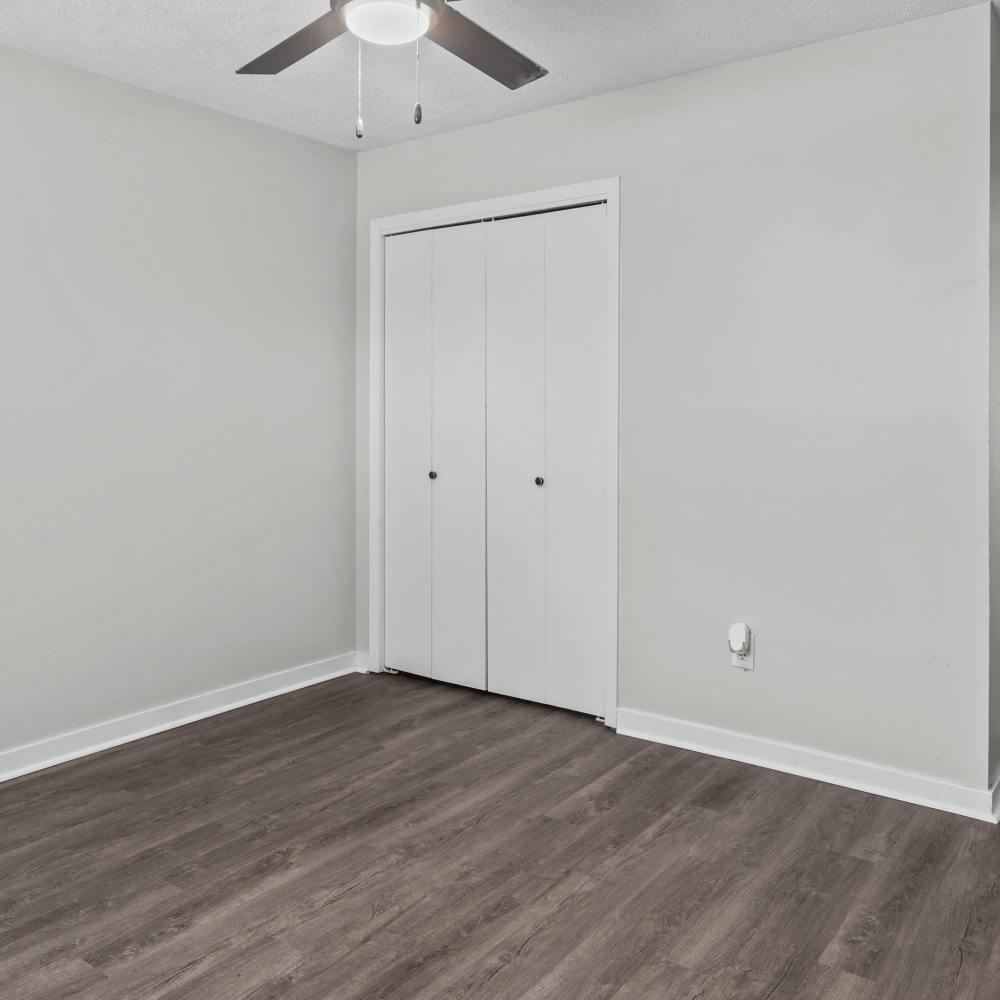 Charming bedroom with modern finishes and sleek laminate flooring at Pecan Ridge in Vicksburg, Mississippi.