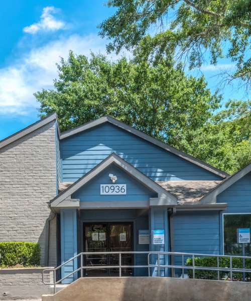 Property exterior with parking in the front at Warwick at Westchase in Houston, Texas