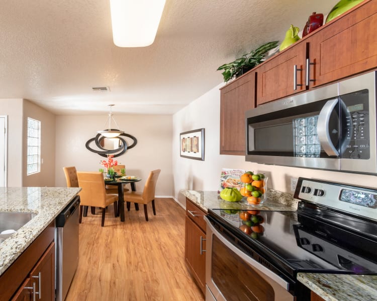 Cozy living room and kitchen/dining room with hardwood flooring at The Palisades in Paradise Valley