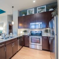 Gourmet kitchen with stainless-steel appliances and pendant lighting at Imperial Lofts in Sugar Land, Texas