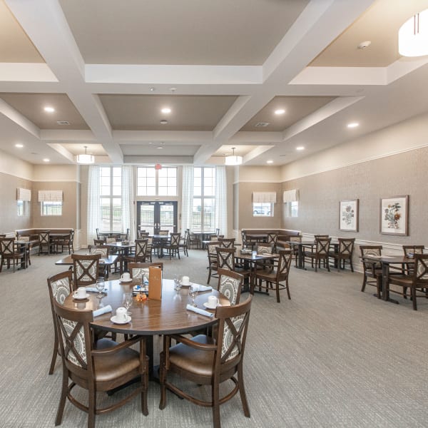 Spacious indoor dining room with plenty of seating at The Madison Senior Living in Kansas City, Missouri
