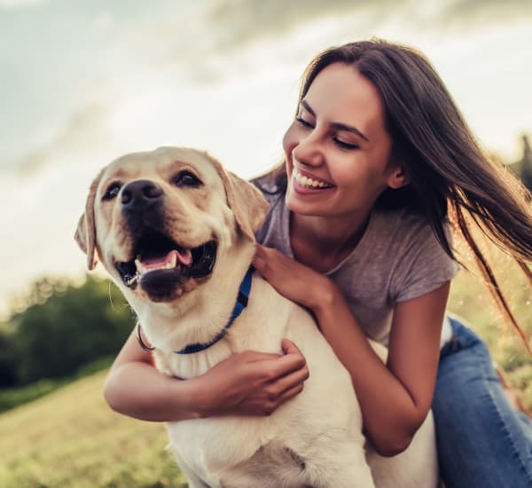 Woman hugging her dog in Salem, Oregon near The Fairway Apartments