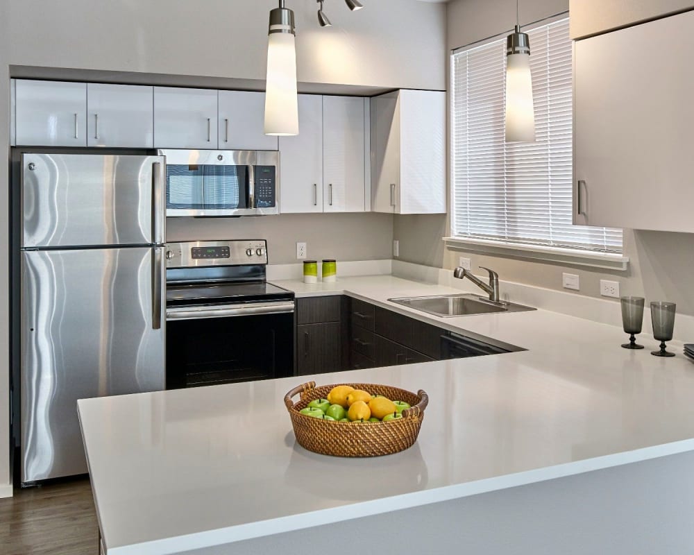 Kitchen with a breakfast bar at The Maverick in Burien, Washington