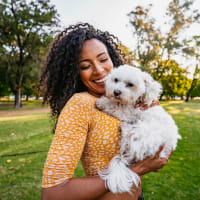 Woman with her dog at Capri Creek Apartments in Petaluma, California