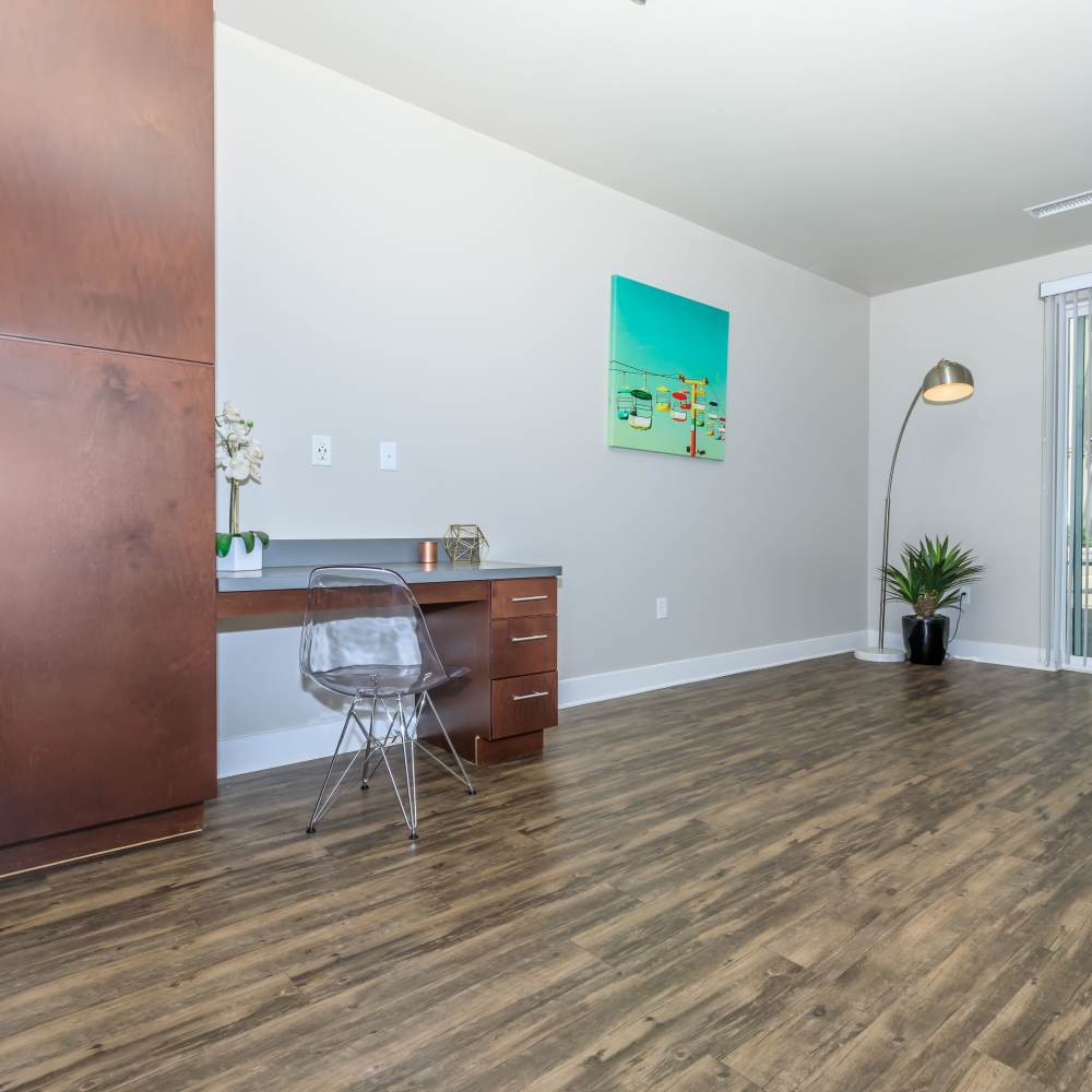 Unfurnished living room with desk and hard wood -style flooring at Park Place Olde Town Apartments in Arvada, Colorado