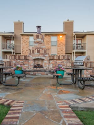 Outdoor fireplace with benches at Cimarron Trails Apartments in Norman, Oklahoma