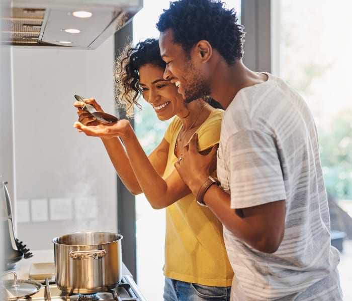Couple cooking together in their kitchen at The Lyndon in Irving, Texas