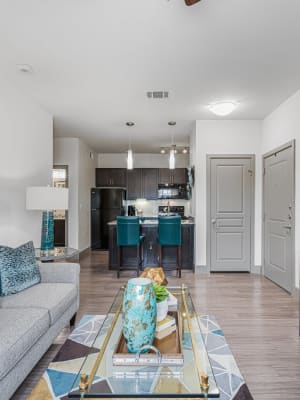 Model living room with a ceiling fan and at The Residences at Panther Hollow in Marble Falls, Texas