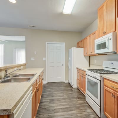 A kitchen with appliances in a home at The Village at Whitehurst Farm in Norfolk, Virginia