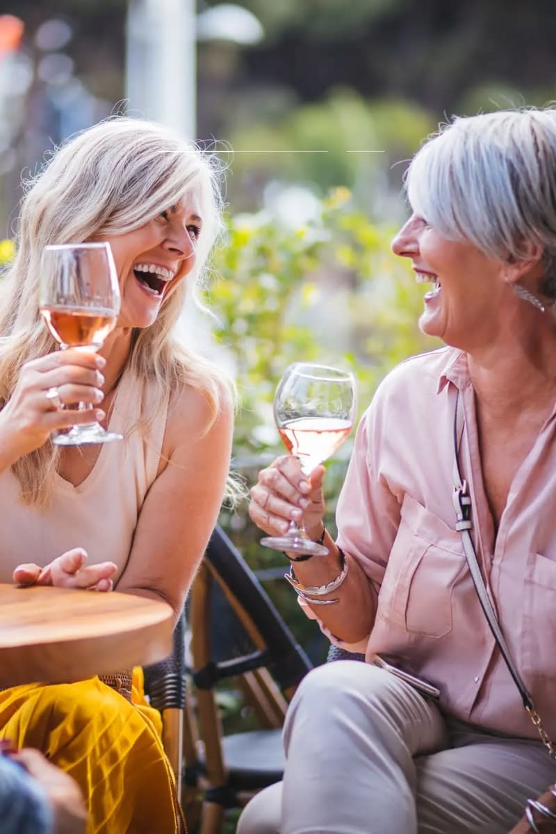 Resident sharing a glass of wine at Village on the Park Steeplechase in Houston, Texas