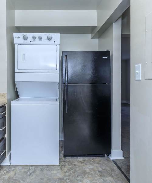 Kitchen with refrigerator and washer & dryer at Parkland Village in District Heights,Maryland