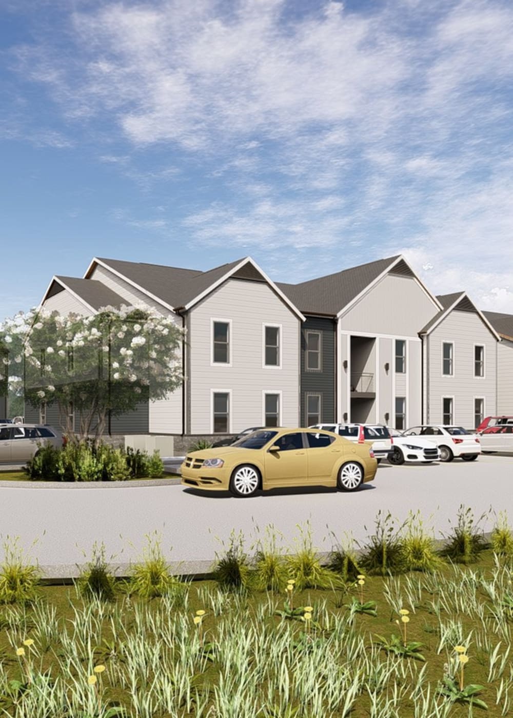 View of exterior of apartments and vehicles parked in front of Landry Commons in Lafayette, Louisiana