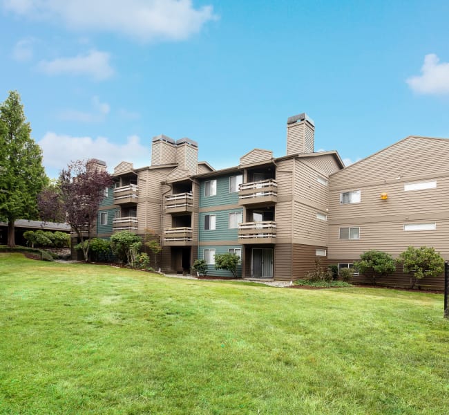 Exterior building view. open grassy landscape at Latitude Apartments in Everett