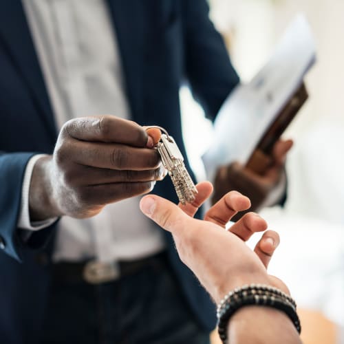 A resident being handed keys to a home at Gateway Village in San Diego, California