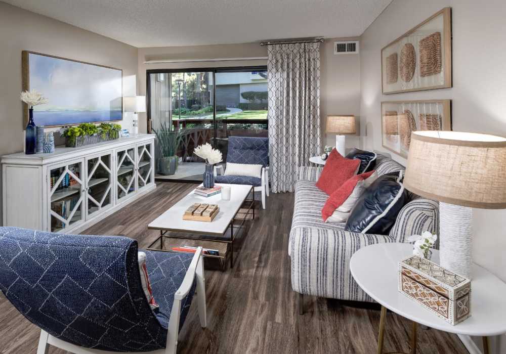 Stylish living room with large sofa and coffee-table at Parcwood Apartments in Corona, California