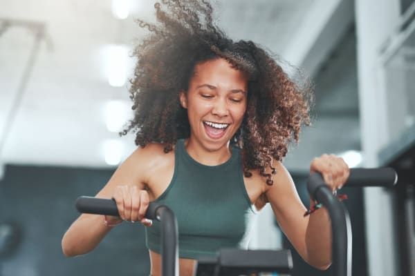 A resident working out on a bike in the fitness center Haven Hill Exchange in Atlanta, Georgia