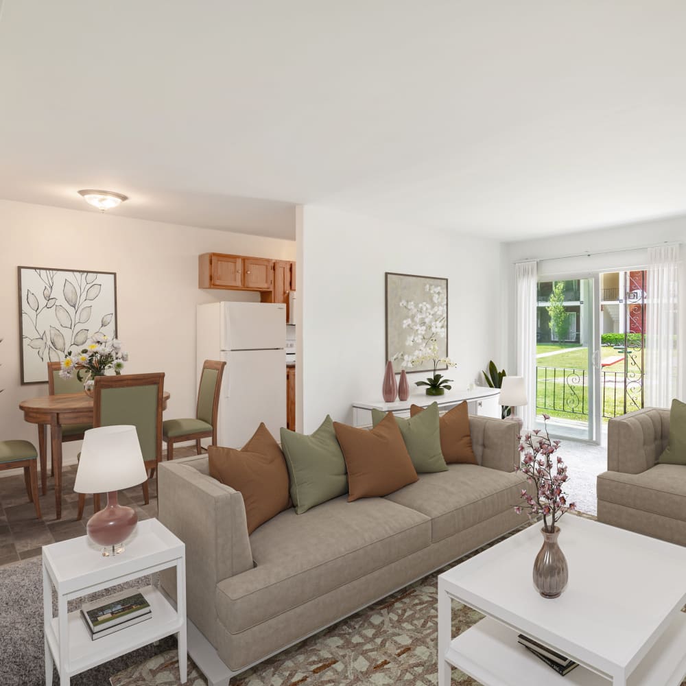 Model living room with sliding door access to a private patio at Edgewater Gardens Apartment Homes in Long Branch, New Jersey