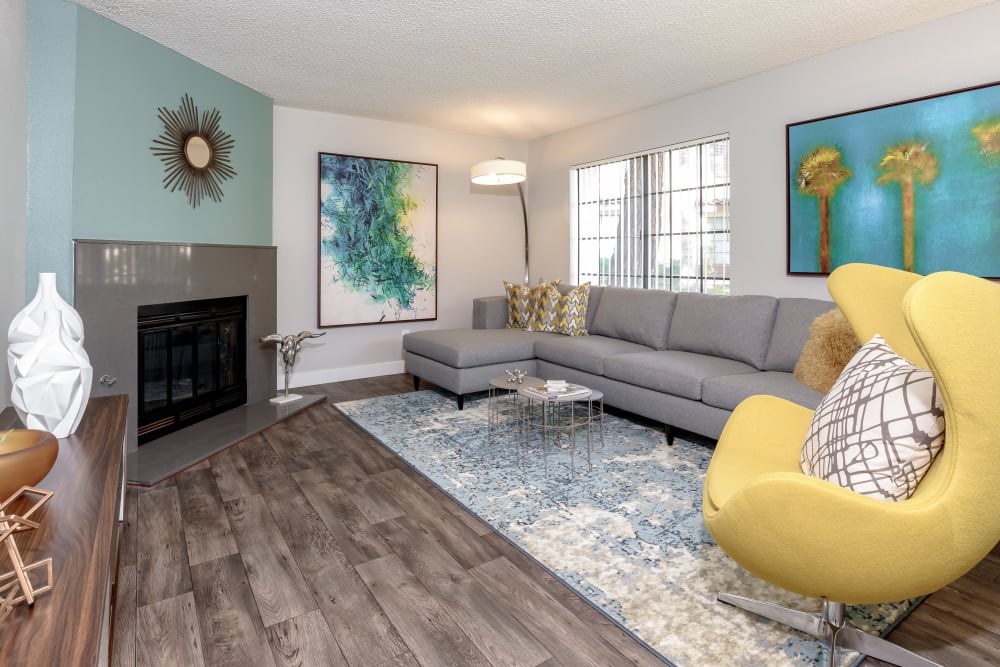 Spacious living room with two large windows and a fireplace at Sonora at Alta Loma in Alta Loma, California