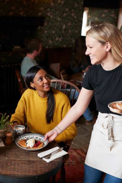 Resident woman eating at a restaraunt near City Limits Apartments in Columbia, Tennessee
