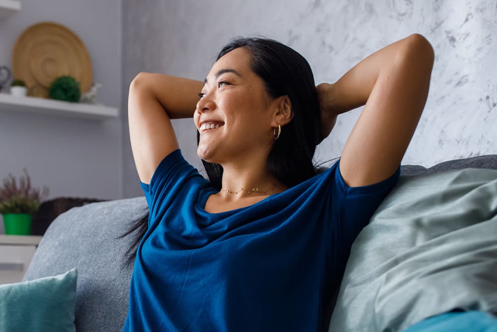 Resident relaxing at home at Mission Apartments in San Diego, California