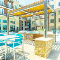BBQ setup beside the pool at Millennium Place in Corinth, Texas