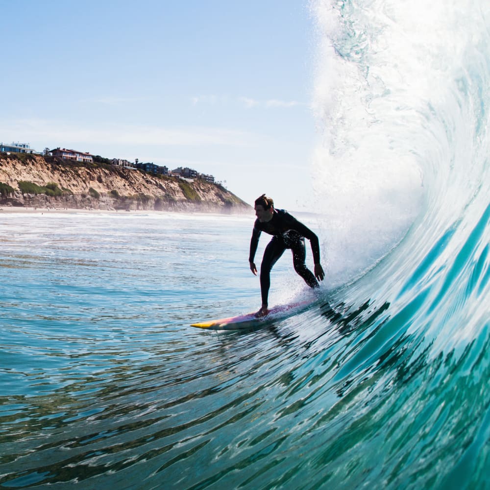 Surfing at beach near Bridgeview Apartments in San Diego, California