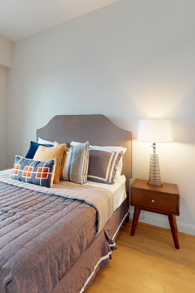A cozy bedroom at 55 Brighton at Packard Crossing in Boston, Massachusetts