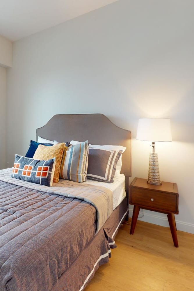 A cozy bedroom at 55 Brighton at Packard Crossing in Boston, Massachusetts