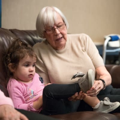 Resident playing with a child at Towerlight in St. Louis Park, Minnesota.