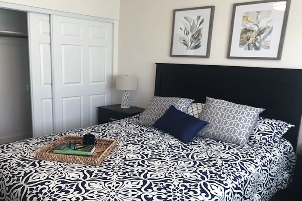 A serene bedroom in an apartment at Blossom Vale Senior Living in Orangevale, California.