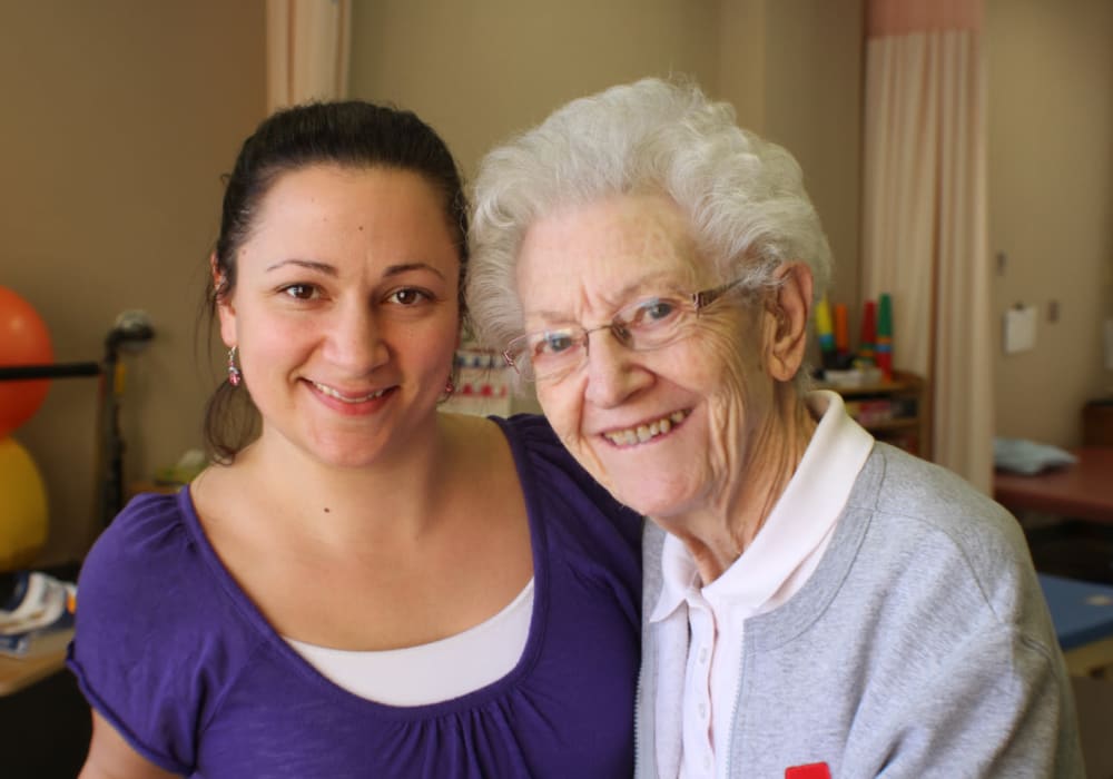 Resident and physical therapist in the onsite gym at Edgerton Care Center in Edgerton, Wisconsin